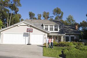 Family Standing Outside House