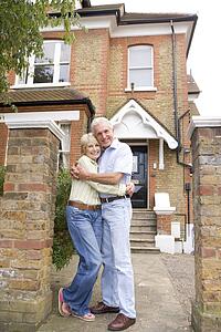 Couple Standing Outside Their House