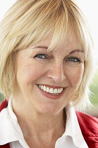 Portrait Of Middle Aged Woman Smiling At Camera
