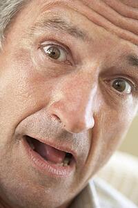 Portrait Of Senior Man Looking At Camera In Surprise