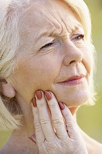 Portrait Of Senior Woman With A Toothache