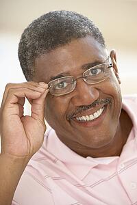 Portrait Of Middle Aged Man Trying On Glasses