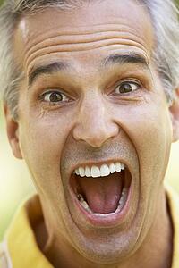 Portrait Of Middle Aged Man With His Mouth Open In Surprise