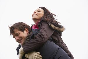 Man Giving His Wife Piggy Back Ride