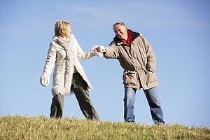 Senior Man Pulling His Wife By The Hand