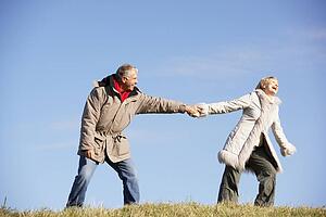 Senior Man Pulling His Wife By The Hand