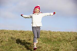 Young Girl Running In The Park