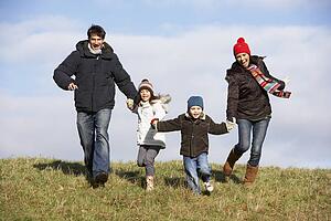 Family Running In The Park