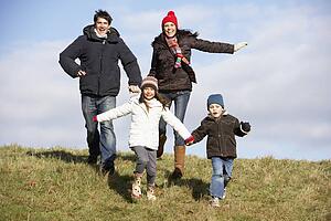 Family Running In The Park