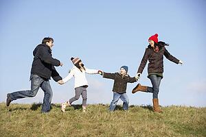 Family Running In The Park