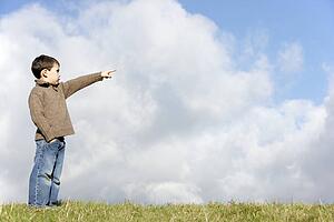 Young Boy Standing In The Park