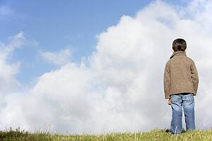 Young Boy Standing In The Park