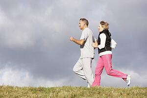 Senior Couple Jogging In The Park