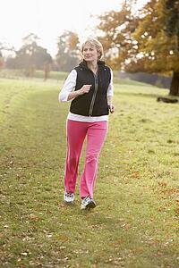 Senior Woman Power Walking In The Park
