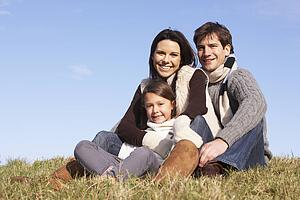 Family Sitting In Park