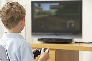Young Boy Playing With Game Console