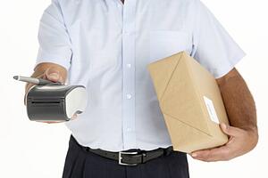 Courier Holding A Parcel And An Electronic Clipboard