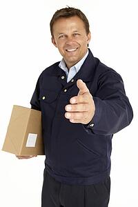 Courier Extending His Hand For A Handshake And Holding A Parcel
