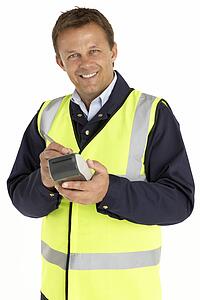 Courier Writing On An Electronic Clipboard, Smiling At The Camera