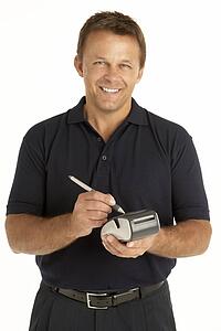 Courier Writing On An Electronic Clipboard, Smiling At The Camera