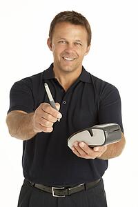 Courier Writing On An Electronic Clipboard, Smiling At The Camera
