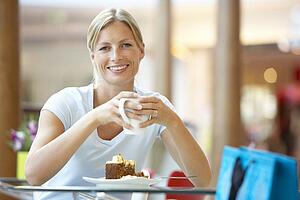 Woman Eating A Piece Of Cake At The Mall