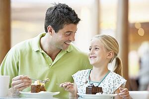 Father And Daughter Having Lunch Together At The Mall