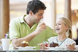 Father And Daughter Having Lunch Together At The Mall