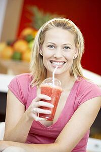 Woman Drinking A Berry Smoothie