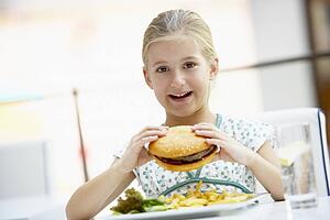 Girl Eating Lunch At A Cafe