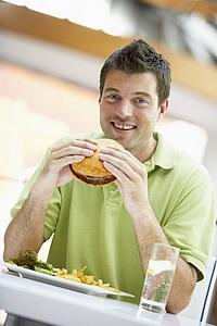 Man Eating Lunch At A Cafe