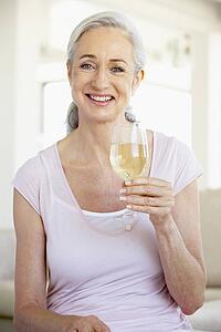 Woman Enjoying A Glass Of White Wine