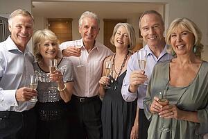 Friends Enjoying A Glass Of Champagne At A Dinner Party