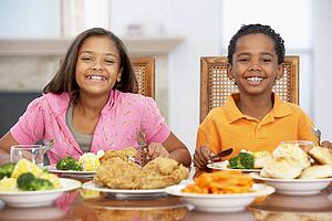 Brother And Sister Having Lunch Together At Home