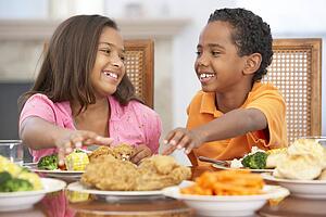 Brother And Sister Having Lunch Together At Home