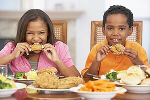 Brother And Sister Having Lunch Together At Home