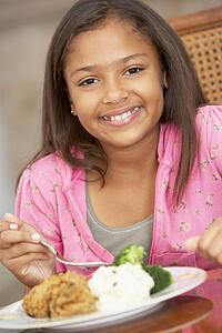 Young Girl Enjoying A Meal At Home