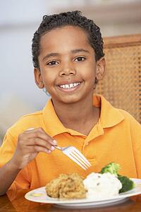 Young Boy Enjoying A Meal At Home