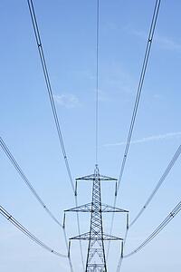 Electricity Pylons Against A Blue Sky