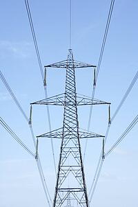 Electricity Pylons Against A Blue Sky