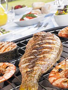 Fish And Prawns Cooking On A Grill