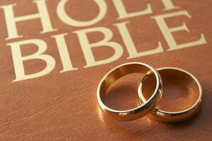 Wedding Rings Resting On A Holy Bible