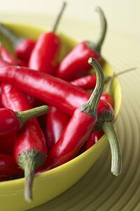 Red Chili Peppers In A Green Bowl