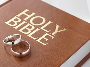 Wedding Rings Resting On A Holy Bible