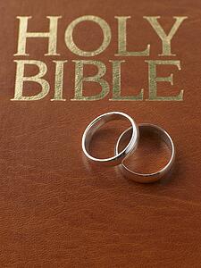Wedding Rings Resting On A Holy Bible