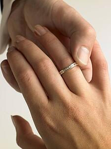 Man Putting Diamond Ring On Woman's Finger