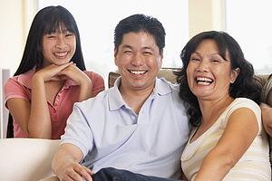 Family Sitting Together At Home