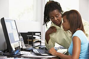 Woman Watching Her Daughter Use A Computer