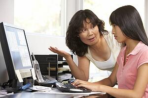 Woman Watching Her Daughter Use A Computer
