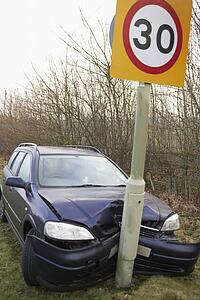 Car Wrapped Around Speed Limit Sign